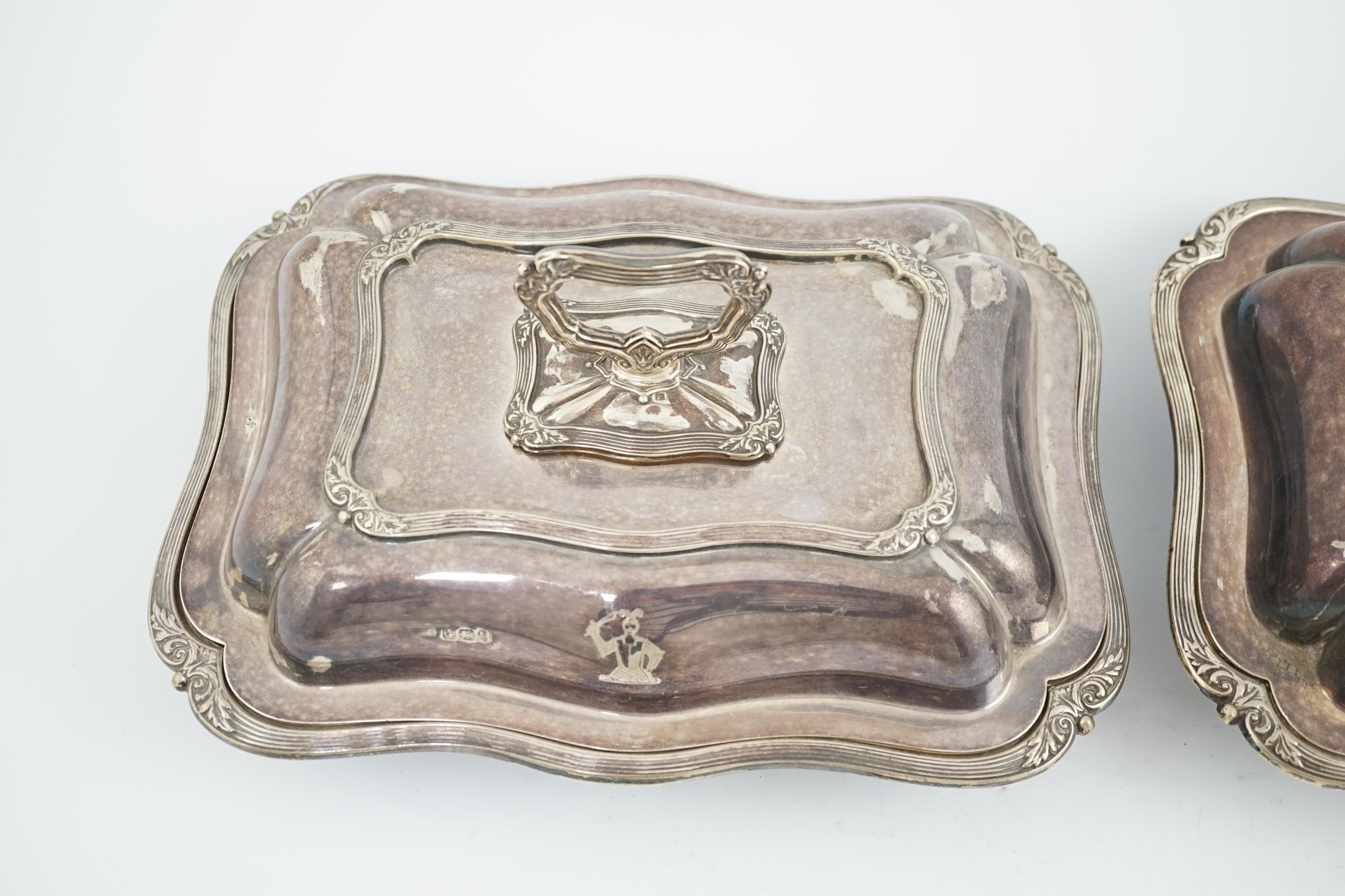 A pair of late Victorian silver entreé dishes and covers, with handles, by Harrison Brothers